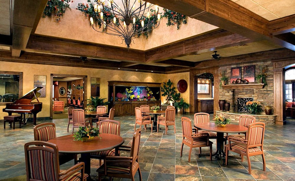 Carefree clubhouse lounge with a grand piano, chandelier, aquarium and stone fireplace