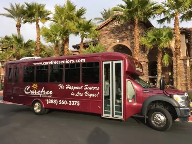 The maroon Carefree FUN Bus parked outside The Willows clubhouse in Las Vegas