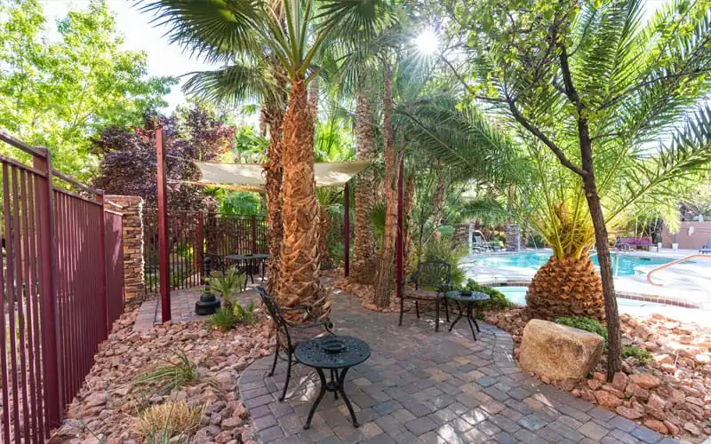 Shaded outdoor seating area at The Willows senior community