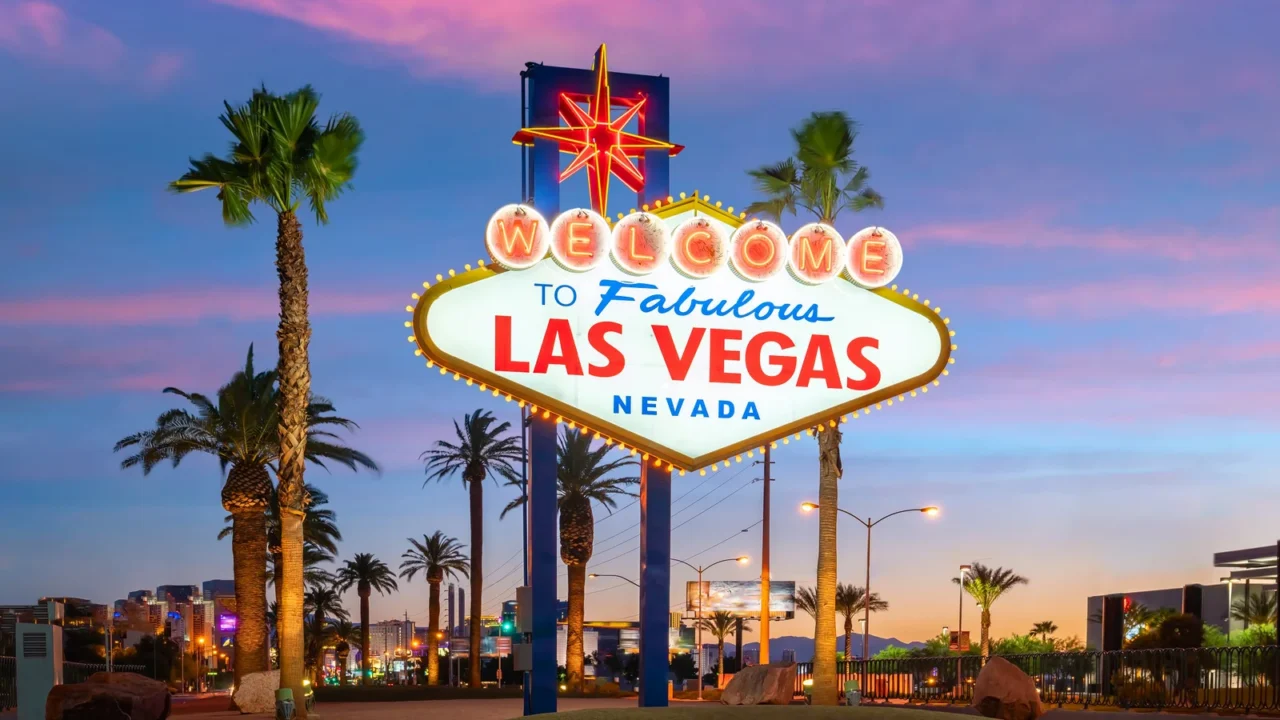 Welcome to Fabulous Las Vegas Nevada sign at sunset with palm trees